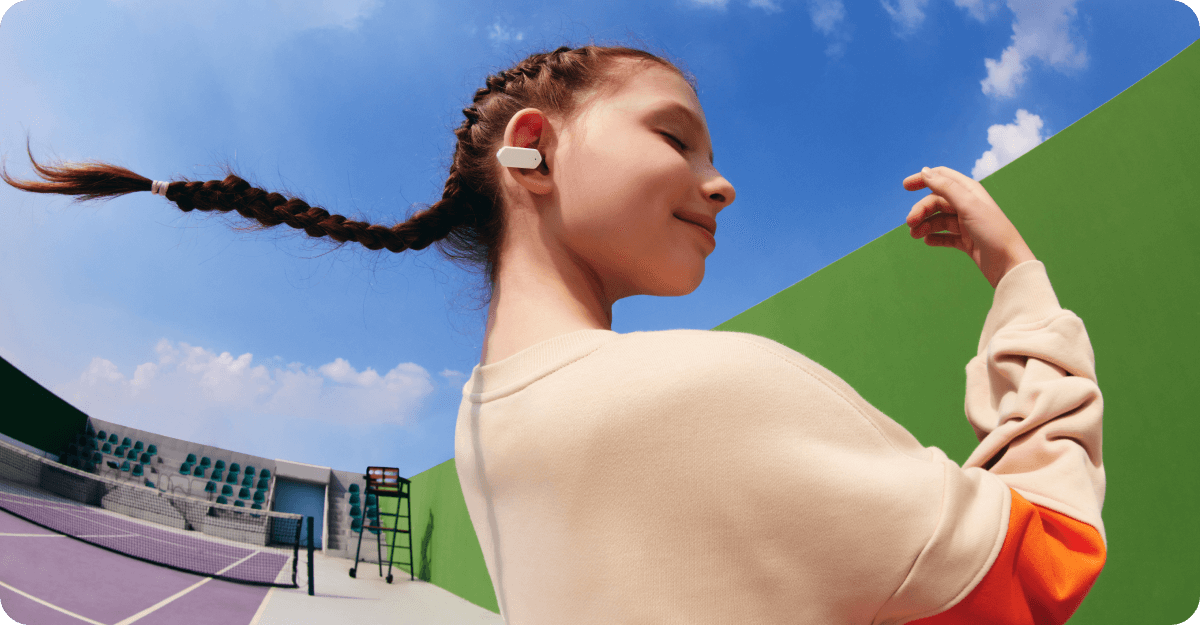 Mädchen mit weißen imoo Openbuds E5 Kopfhörern auf einem Tennisplatz, entspannt bei klarem Himmel