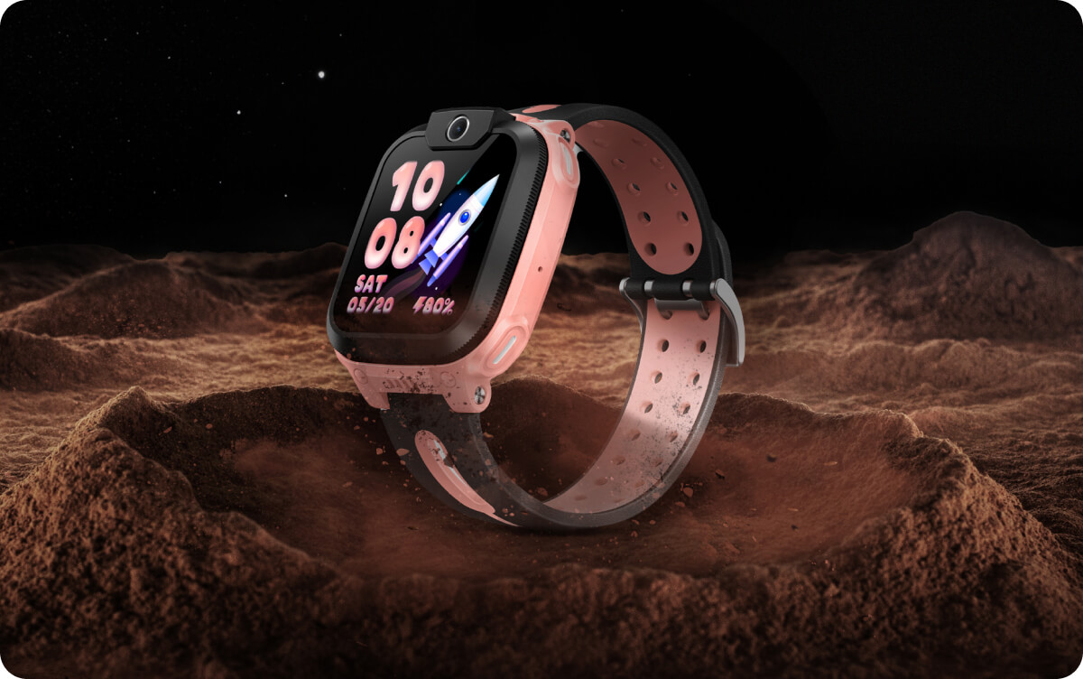 imoo Watch Phone Z1 in Rosa/Grün mit atmungsaktivem Armband, zeigt die Uhrzeit auf dem Display in einer Kraterlandschaft.