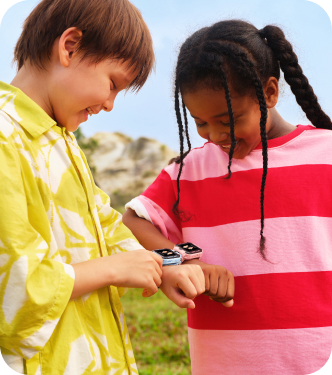 Boy and girl showing their imoo Z7 smartwatches at the gym, both with a butterfly icon on the display.